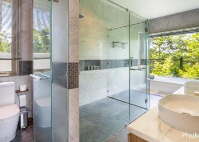 Modern bathroom with glass shower and double sinks