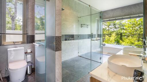 Modern bathroom with glass shower and double sinks