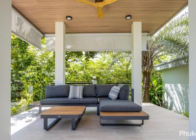 Cozy outdoor seating area with modern furniture and lush greenery