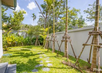 Outdoor garden area with palm trees and stepping stones