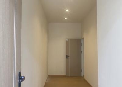 A hallway with doors and recessed lighting