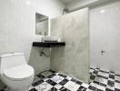 Modern bathroom with tiled walls and floor, featuring a toilet, sink, and spacious shower area.