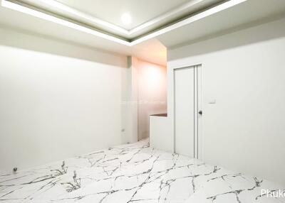 Minimalist room with marble floor and recessed ceiling lights