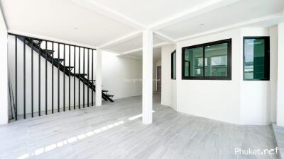 Spacious living area with staircase and large window