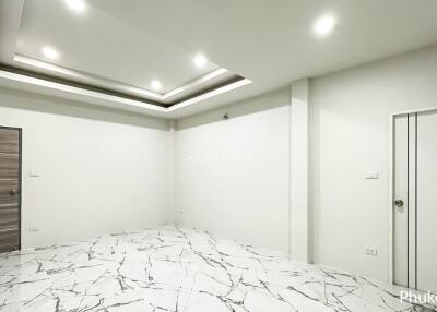 modern living space with marble floor and recessed lighting