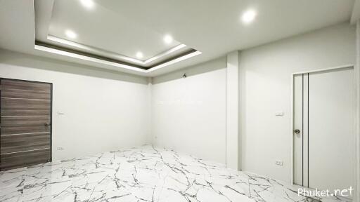 modern living space with marble floor and recessed lighting