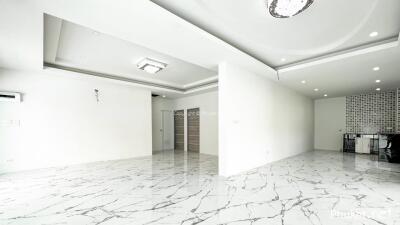 Spacious living room with marble flooring and modern ceiling design