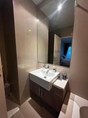 Modern bathroom with a large mirror and sink