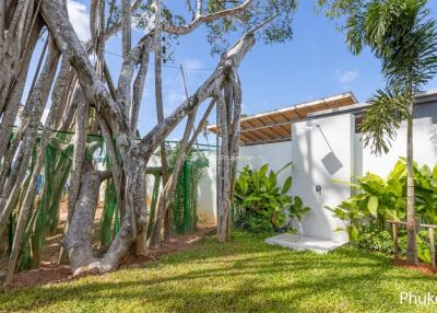 Backyard with large tree and outdoor shower