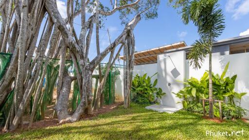 Backyard with large tree and outdoor shower