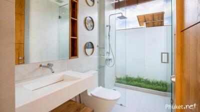 Modern bathroom with glass shower and white fixtures