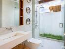 Modern bathroom with glass shower and white fixtures