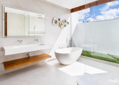 Modern bathroom with freestanding tub, glass shower, and large mirror