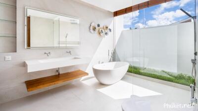 Modern bathroom with freestanding tub, glass shower, and large mirror