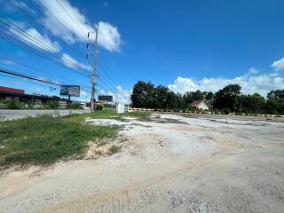 Empty plot of land under a clear blue sky