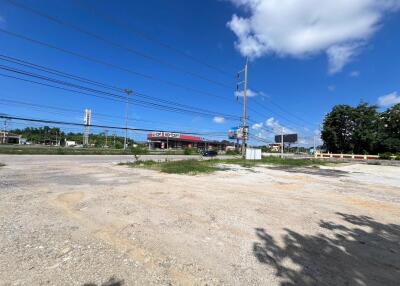 Vacant land near a commercial area with clear skies