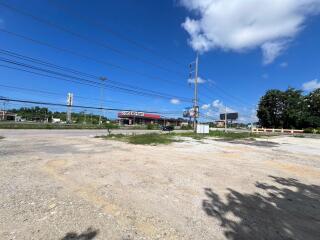 Vacant land near a commercial area with clear skies