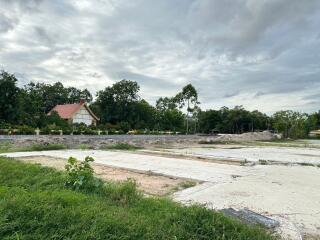 Vacant land with a house in background