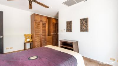 Minimalist bedroom with wooden furniture and art decorations