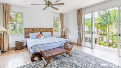 Spacious bedroom with large windows and natural light