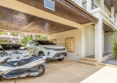 Carport with vehicles parked under a building