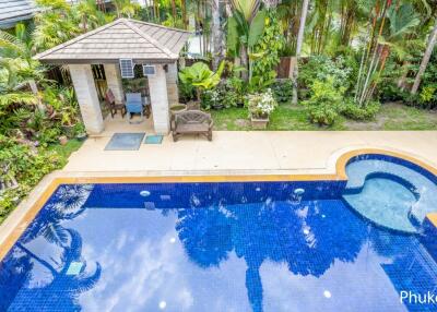 Outdoor area with a swimming pool, jacuzzi, and garden