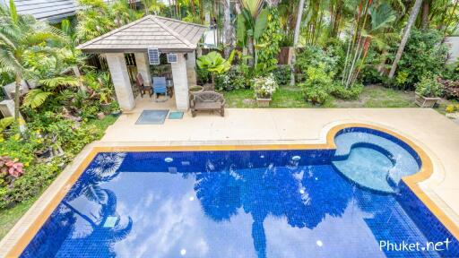 Outdoor area with a swimming pool, jacuzzi, and garden