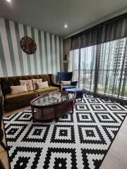 Living room with stylish furniture and a balcony view