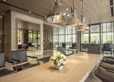Modern communal living area with large table and pendant lighting