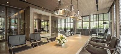 Modern communal living area with large table and pendant lighting