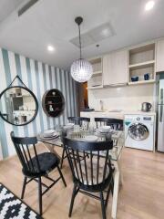 Modern dining area adjacent to a compact kitchen