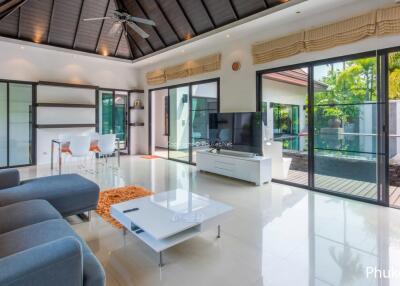 Spacious living room with natural light and pool view