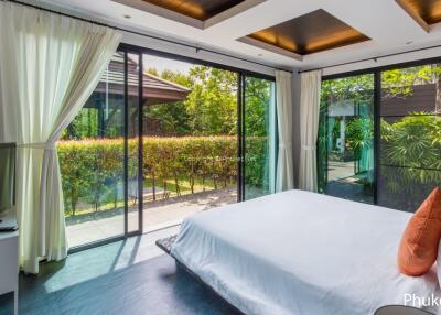 Spacious bedroom with large windows and garden view