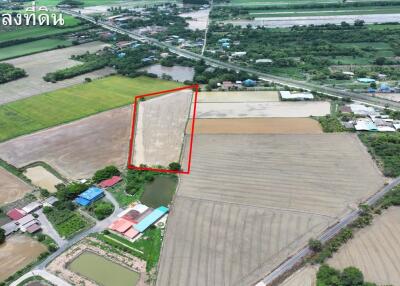 Aerial view of a large plot of land with surrounding farmland and residential buildings