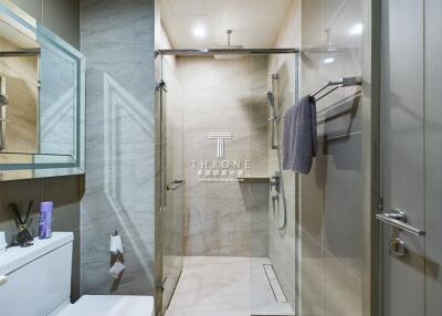 Modern bathroom with glass shower and wall-mounted sink