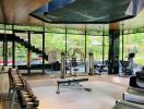 Modern gym with exercise equipment and greenery view