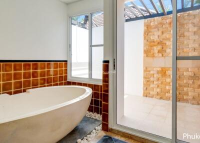 Bathroom with bathtub and outdoor shower area