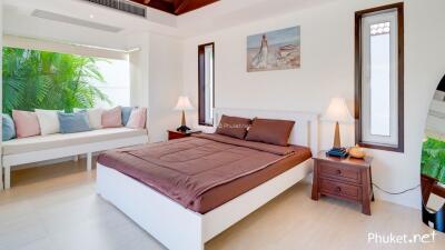 Spacious bedroom with large bed and seating area