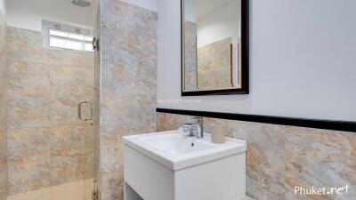 Modern bathroom with sink and walk-in shower