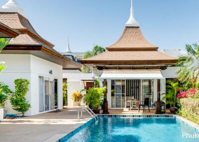 Luxury villa exterior with swimming pool and tropical plants