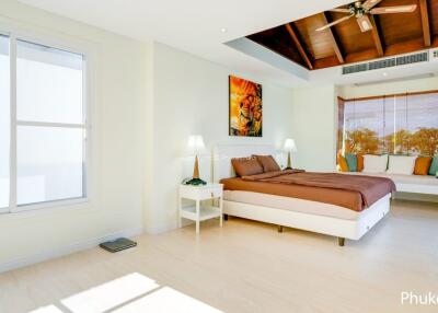 Bright and spacious bedroom with modern decor and a seating area