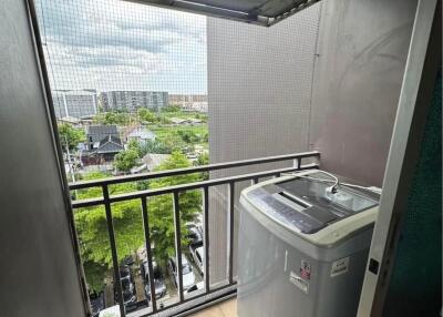 Small laundry room with a washing machine and an outdoor view