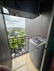 Small laundry room with a washing machine and an outdoor view