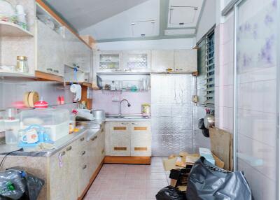 Cluttered kitchen with various household items