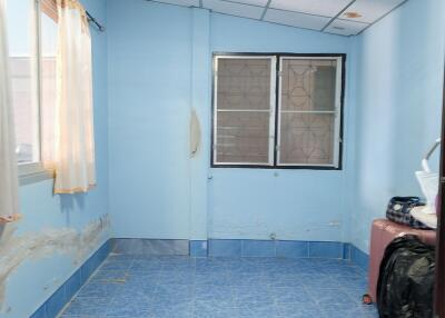 Empty room with blue walls and tiled floor