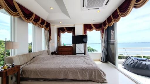 Spacious bedroom with large windows and ocean view