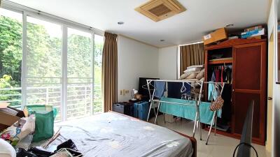 Spacious bedroom with outdoor view, closet, and storage