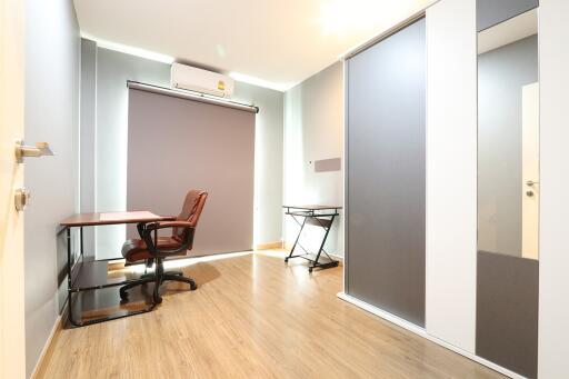 Well-lit home office with wooden flooring and modern furniture