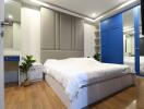 Modern bedroom with blue wardrobe and large bed