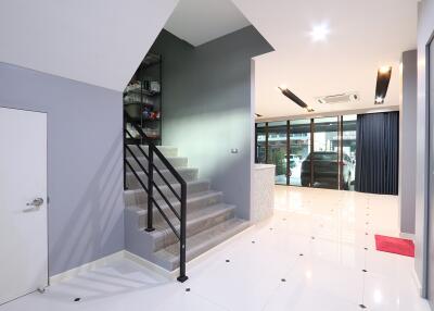 Modern living space with staircase and glossy floor